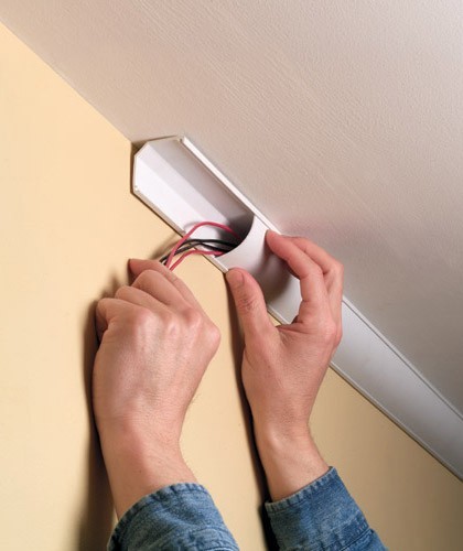 man installing a ceiling corner duct